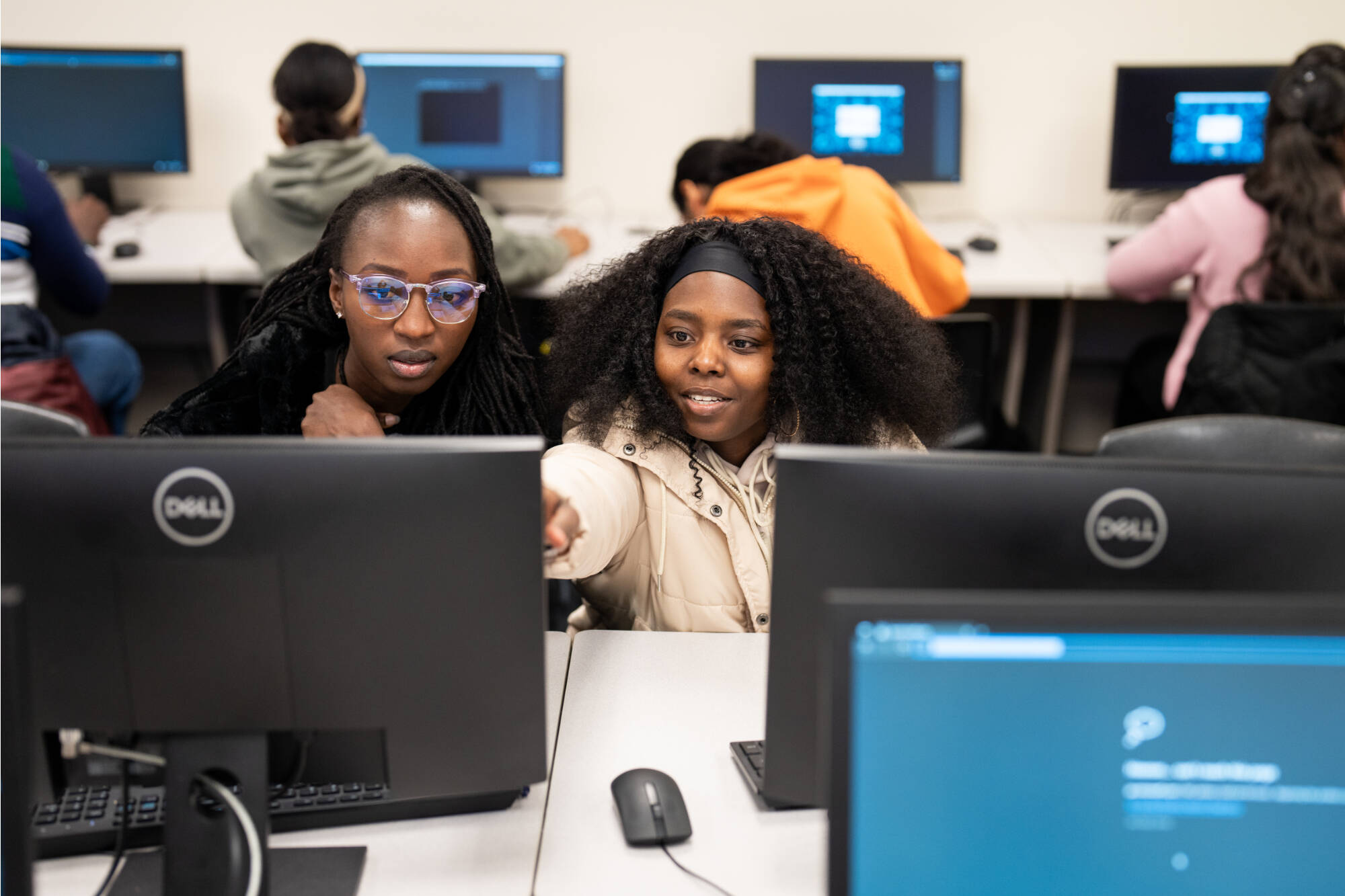 Students from Professor Samah Mansour's computing class work in the Cyber Threat Range.